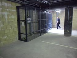 A security gate for an underground car park with a safety cage enclosing the return