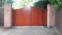 A Bakewell serpentine gate stained in dark oak